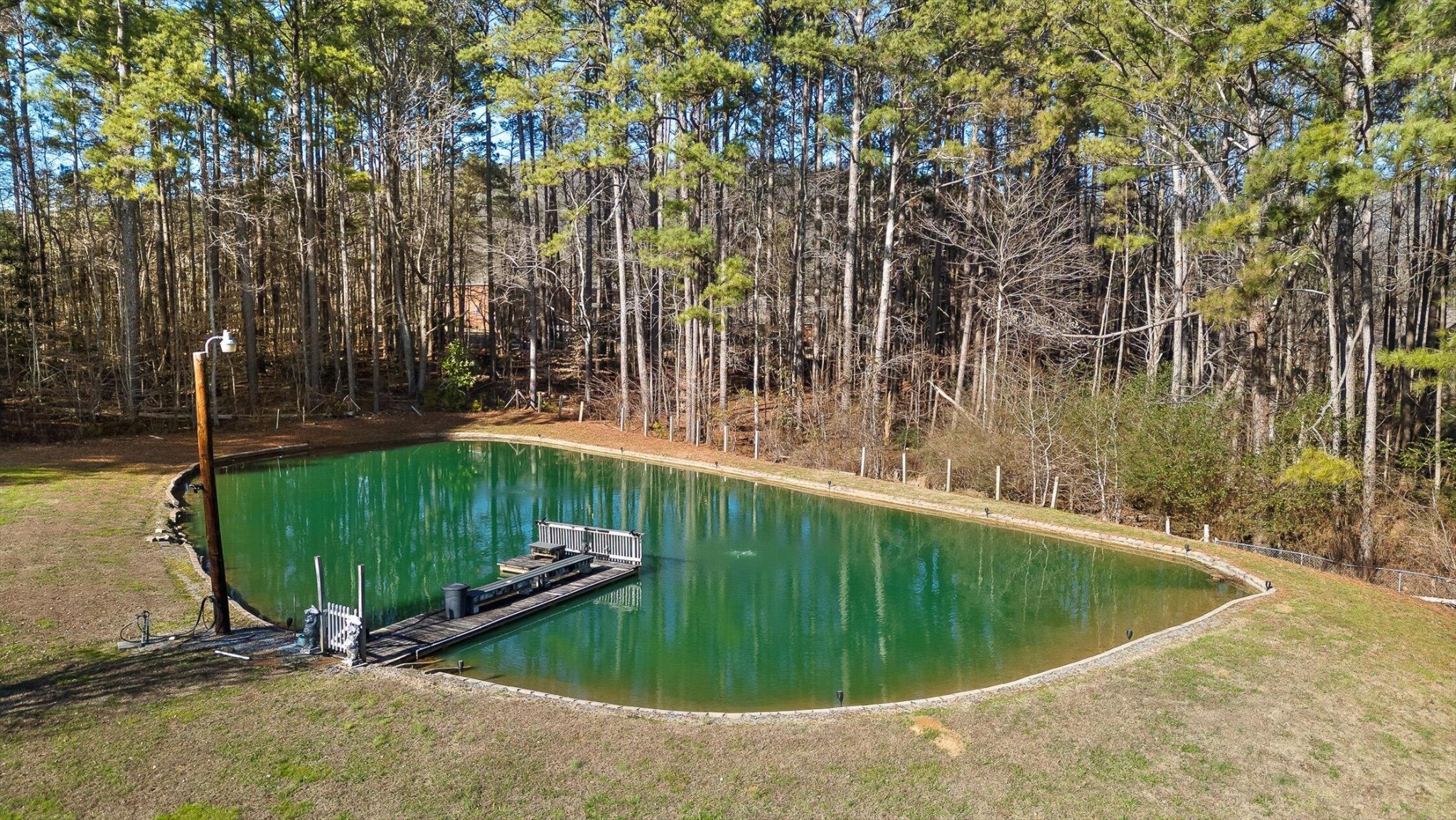 5017 McDonald Road McDonald, TN 37353 - Photo 45 of 52 a view of a swimming pool with a bench and trees in the background
