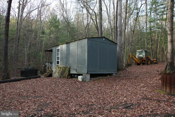 a backyard of a house with barbeque oven table and chairs
