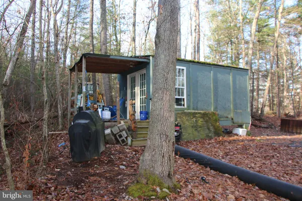 a view of a porch with furniture and a yard