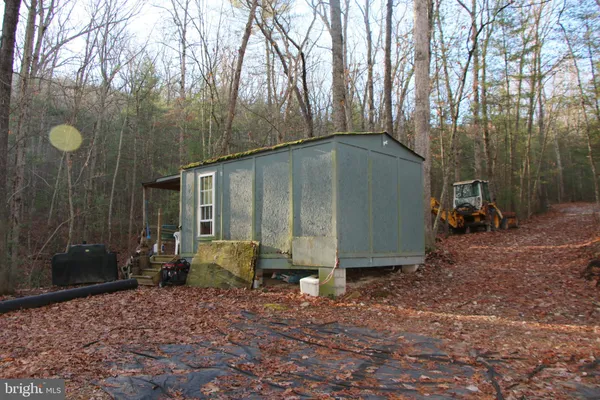 a backyard of a house with barbeque oven and outdoor seating