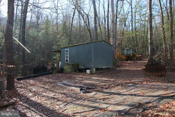 a view of a barn with green space