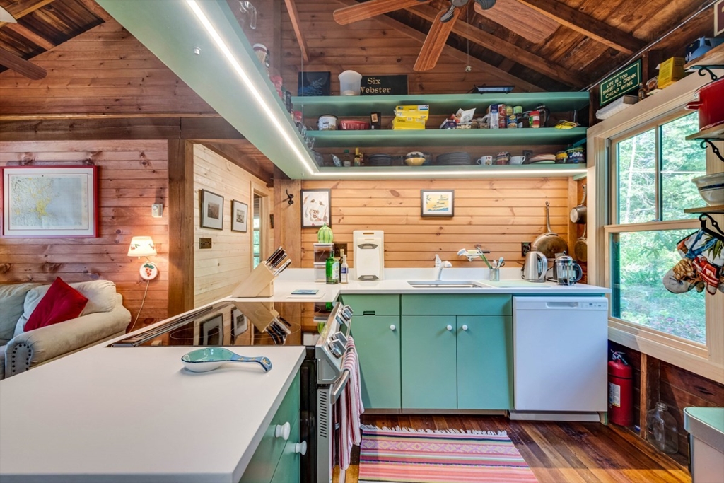 213 Ashby Road Ashburnham, MA 01430 - Photo 11 of 39 a open kitchen with stainless steel appliances granite countertop a sink a stove and a wooden cabinets