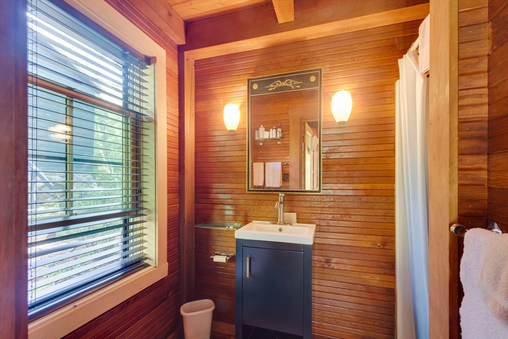 213 Ashby Road Ashburnham, MA 01430 - Photo 23 of 39 a bathroom with a toilet a sink and a large mirror