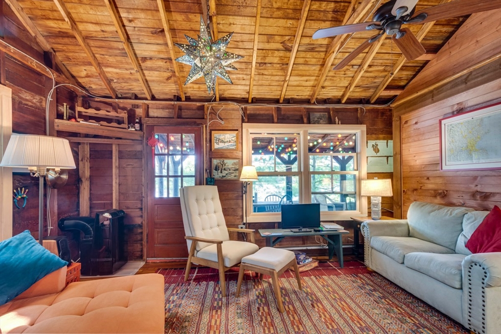 213 Ashby Road Ashburnham, MA 01430 - Photo 7 of 39 a living room with furniture and a chandelier