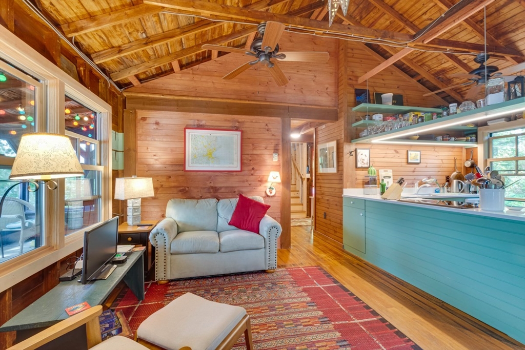 213 Ashby Road Ashburnham, MA 01430 - Photo 8 of 39 a living room with furniture and a floor to ceiling window