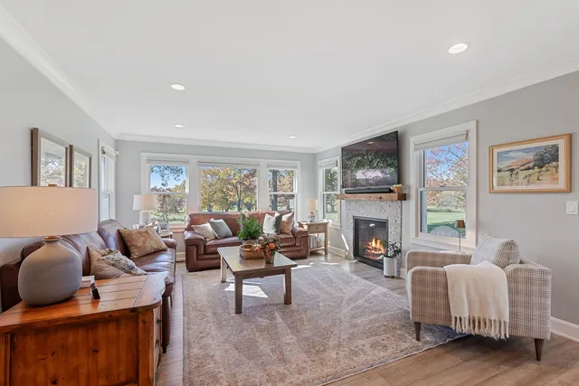 a living room with furniture fireplace and window