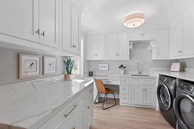 a view of a kitchen sink dishwasher and cabinets with wooden floor