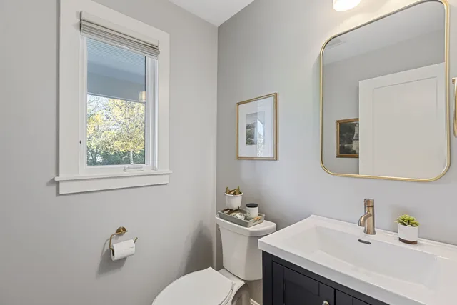 a bathroom with a sink a toilet and mirror
