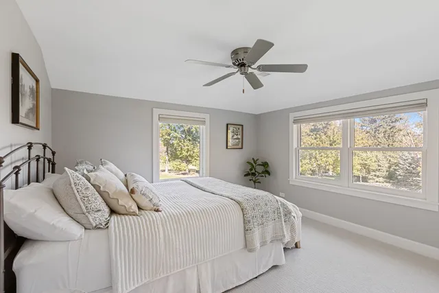 a bedroom with a large bed and a window