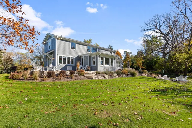 a view of a house with a big yard and sitting area