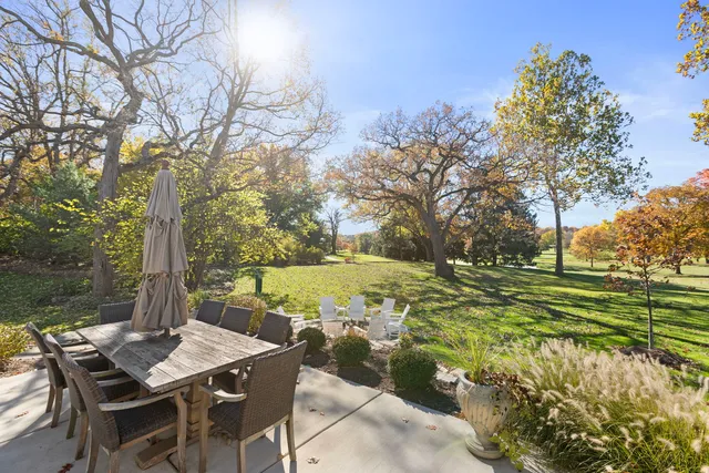 a view of a patio with table and chairs and wooden fence