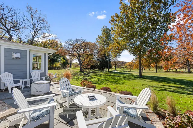 a view of a patio with couches chairs and a big yard