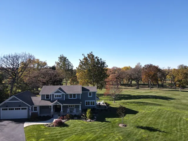 a front view of a house with a garden and swimming pool
