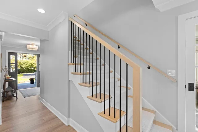 a view of entryway and hall with wooden floor