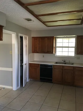 a kitchen with a sink and a refrigerator