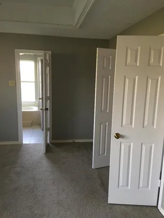 a view of a hallway with a chandelier fan