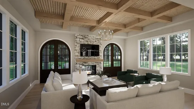 a living room with furniture fireplace and floor to ceiling windows