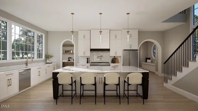 a kitchen with stainless steel appliances granite countertop a stove a sink a dining table and chairs