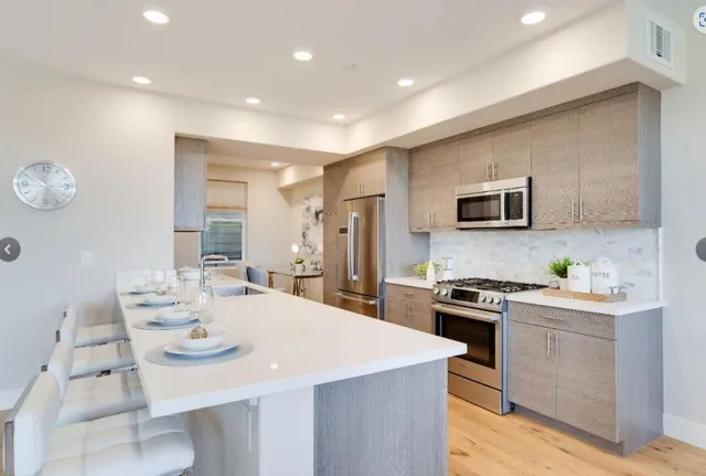 a open kitchen with sink cabinets and wooden floor