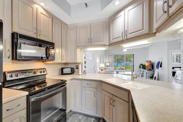 a kitchen with appliances cabinets and a sink