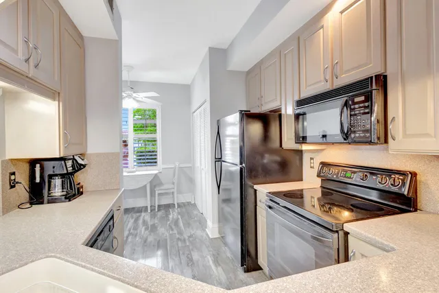 a kitchen with granite countertop a stove and a refrigerator