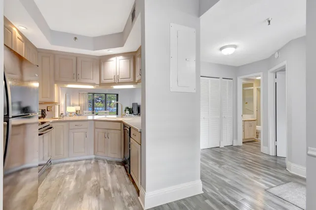 a kitchen with white cabinets and sink