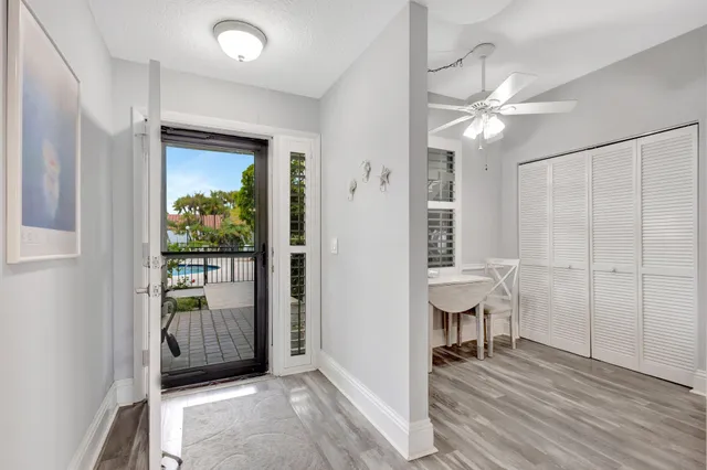 a view of a livingroom with a chair and wooden floor