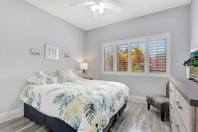 a bedroom with a bed and dresser with mirror