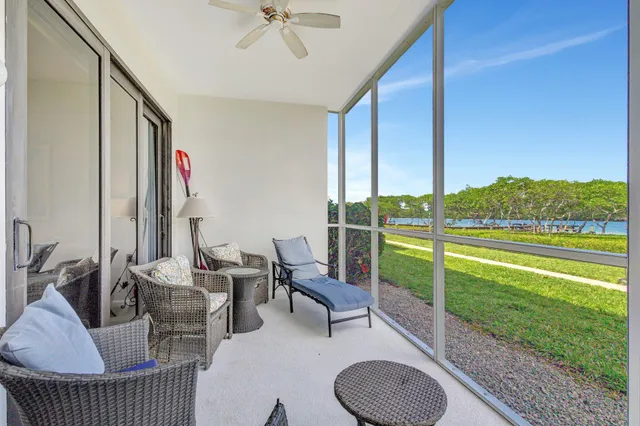 a view of a swimming pool with a lawn chairs and a yard