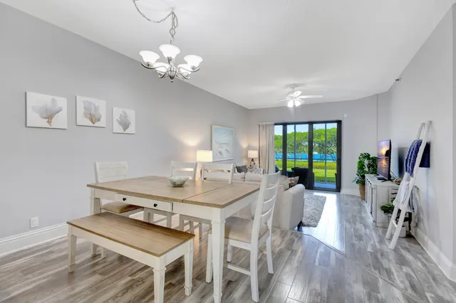 a view of a dining room with furniture wooden floor and chandelier