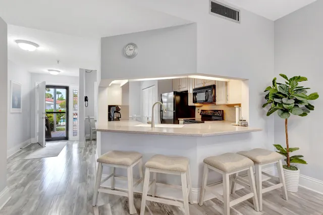 a living room with furniture potted plant and a table