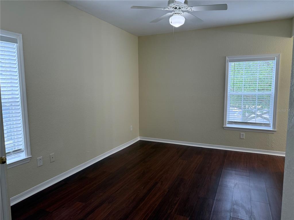 3725 Conroy Road, Unit 2127 Orlando, FL 32839 - Photo 21 of 30 an empty room with wooden floor and windows