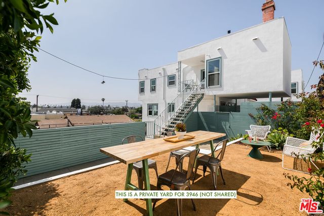 a view of a patio with swimming pool table and chairs