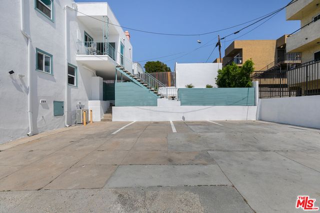 a view of a white building with many windows