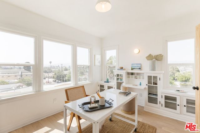 a view of a dining room with furniture large windows and wooden floor