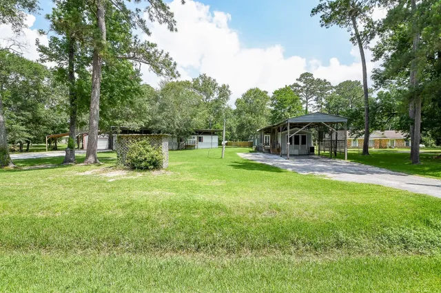a view of a house with a backyard porch and sitting area