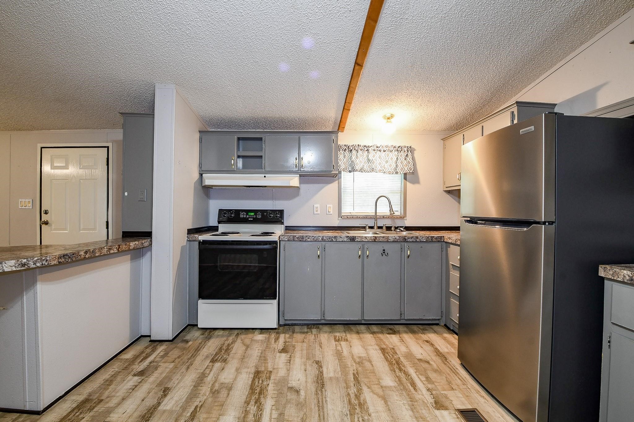 21326 Big Tree Drive Crosby, TX 77532 - Photo 4 of 19 a kitchen with granite countertop a refrigerator stove and sink