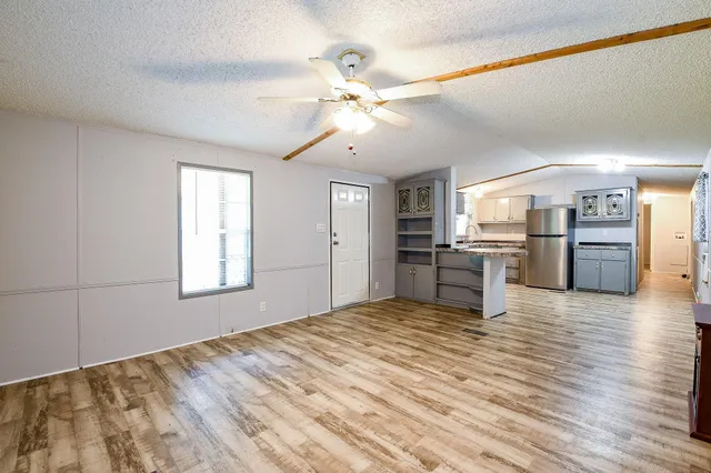 a view of a kitchen with wooden floor and a kitchen