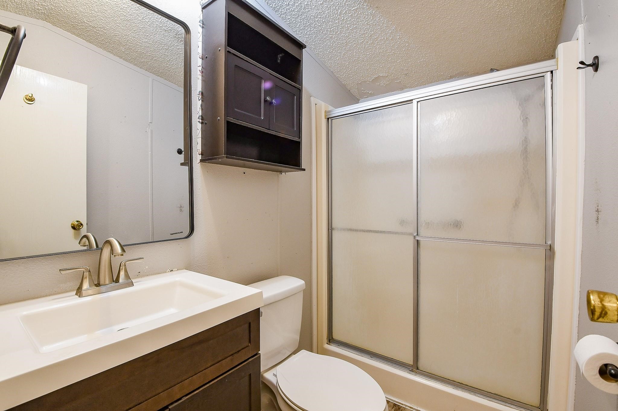 21326 Big Tree Drive Crosby, TX 77532 - Photo 8 of 19 a bathroom with a sink a toilet and shower