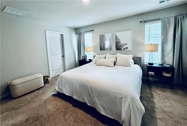 a bedroom with a large bed and a closet