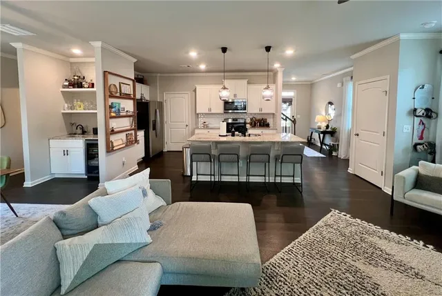 a white kitchen with sink stove and refrigerator