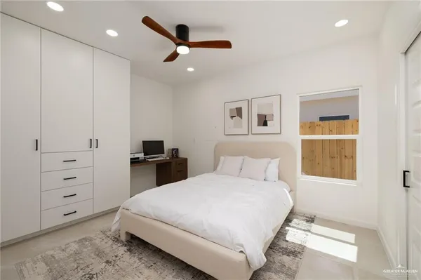 a bedroom with a large bed and a chandelier