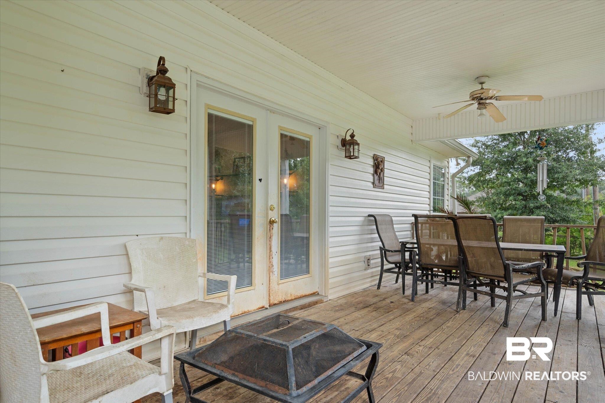 22760 Ridgewood Drive Robertsdale, AL 36567 - Photo 26 of 44 Wooden deck featuring a ceiling fan and outdoor dining space