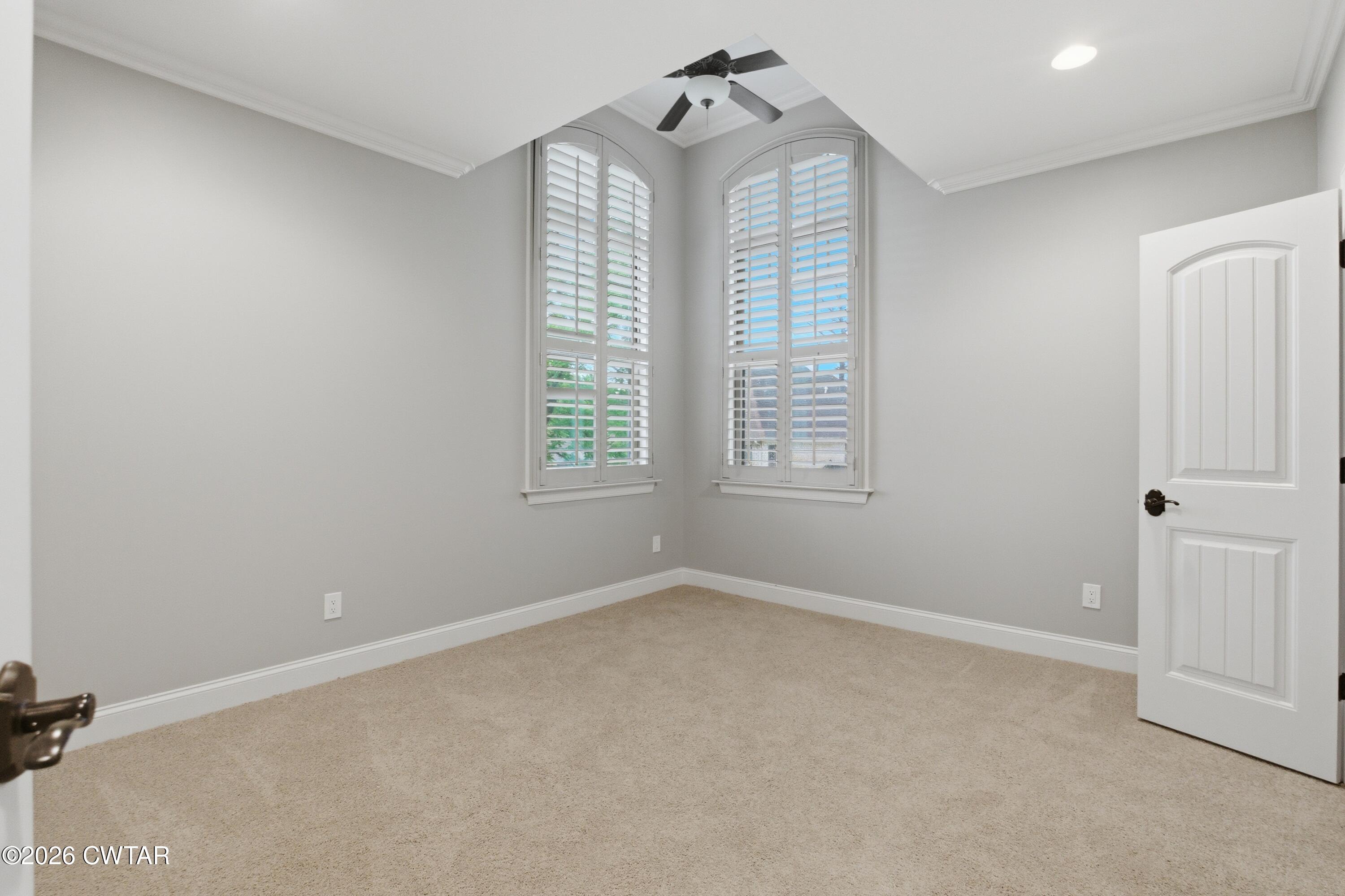 963 Ashport Road Jackson, TN 38305 - Photo 32 of 60 an empty room with windows and chandelier fan