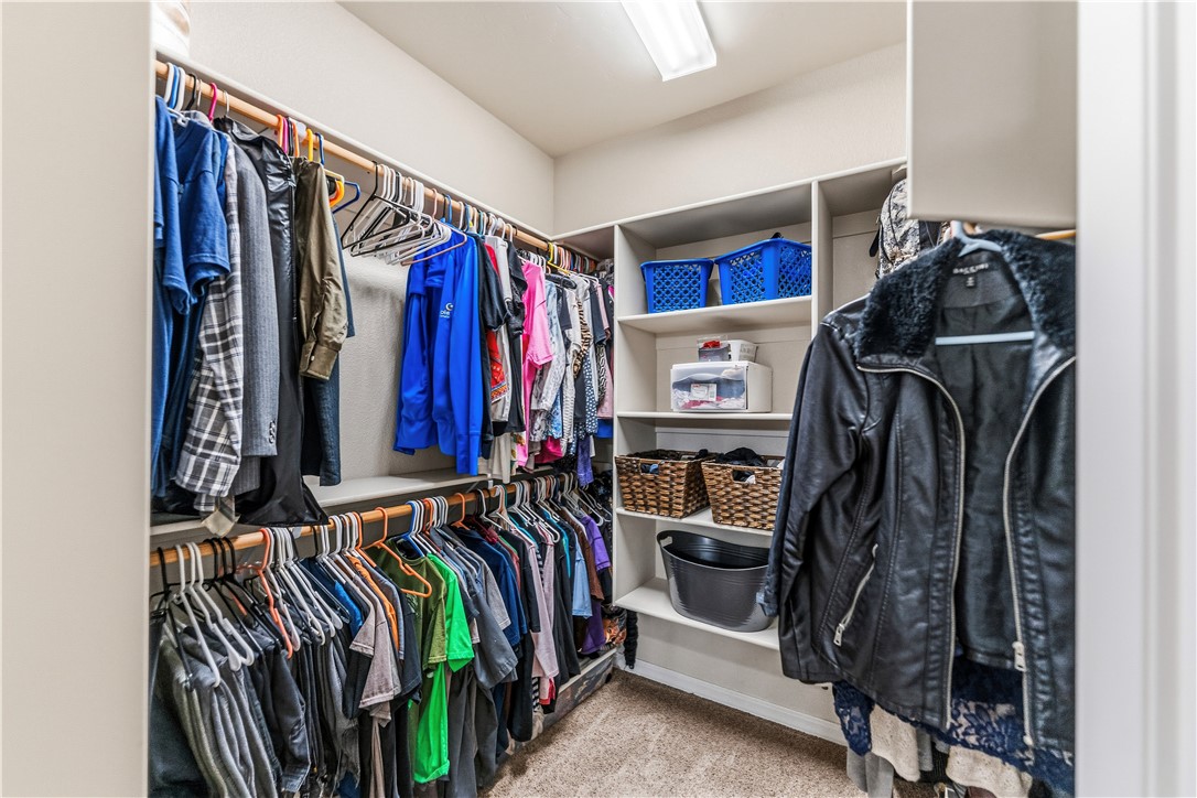 4143 North Stampede Road Kingman, AZ 86401 - Photo 21 of 42 Walk-in closet featuring extensive built-in shelving and multiple hanging rods for organization