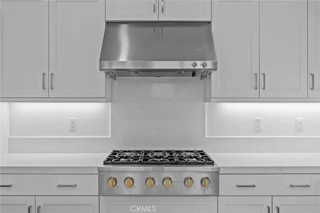 a stove top oven sitting inside of a kitchen