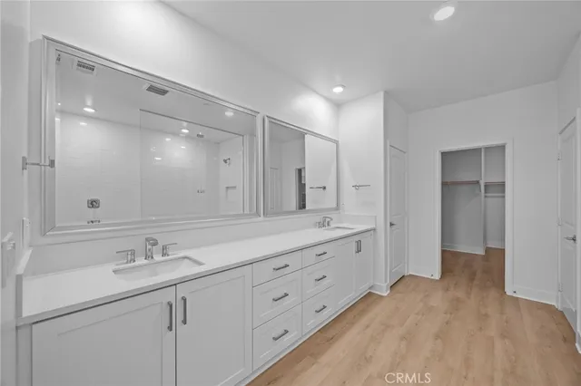 a spacious bathroom with double sink and a large mirror