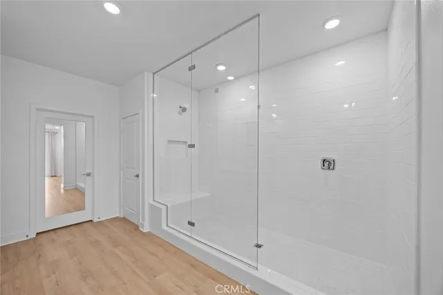 a bathroom with a shower and a glass door