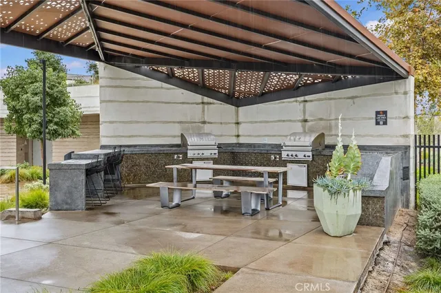 a view of a patio with table and chairs potted plants