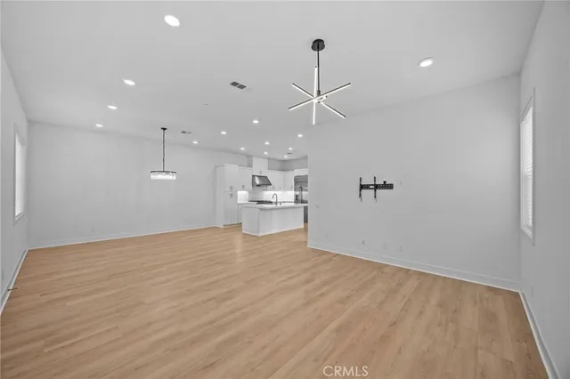 a view of a kitchen with a dishwasher and white cabinets